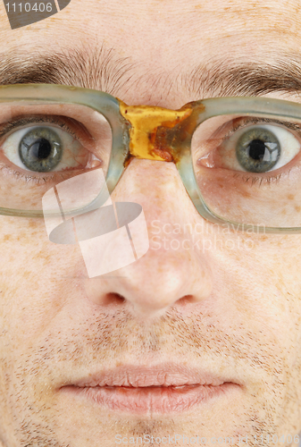 Image of Face in bad old glasses close-up