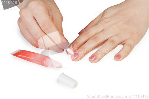 Image of Female hands. Cuticle removal.