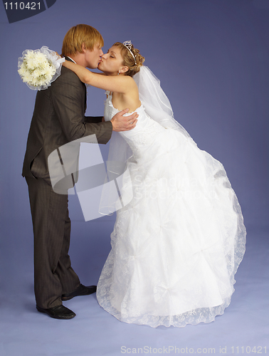 Image of Bride and groom funny kiss