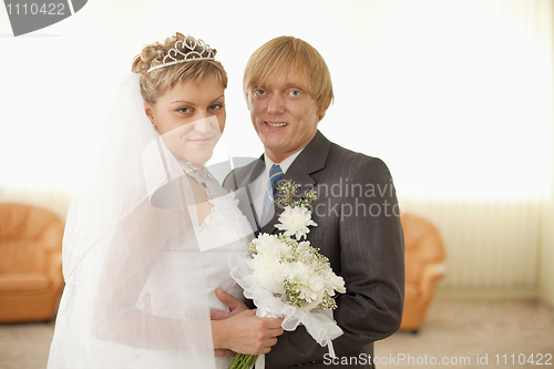 Image of Groom and bride in solemn hall for wedding