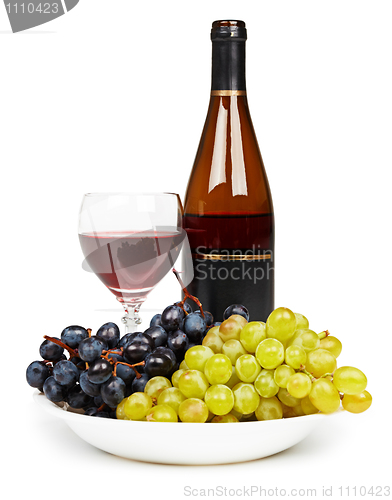 Image of Bottle, glass with red wine and grapes