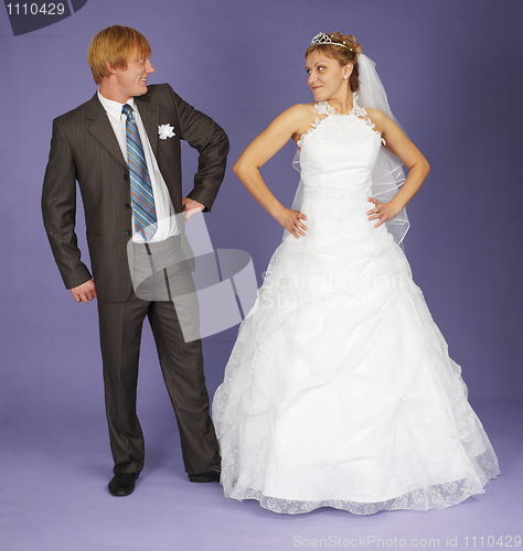 Image of Funny Newlyweds standing on blue