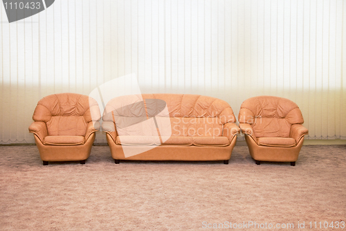 Image of Leather armchairs and sofa in interior of modern room