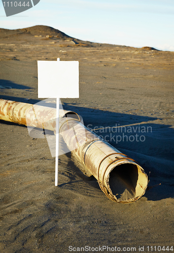 Image of Sign near old rotting pipe - ecological disaster