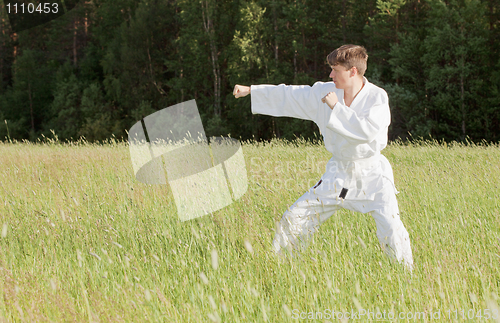 Image of Man in kimono engaged oriental combat sports