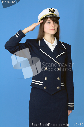 Image of Girl in a sea uniform salutes on blue