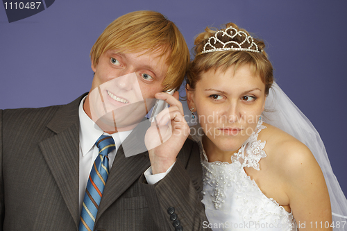 Image of Bride and groom get phone call