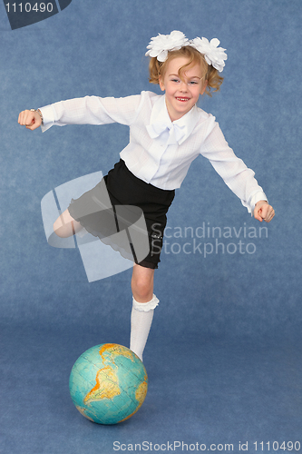 Image of Schoolgirl kicks globe as footballer