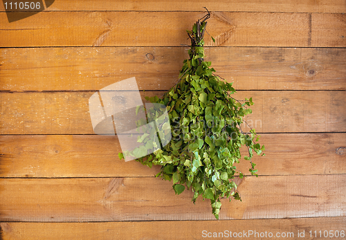 Image of Birch broom hangs in a bath