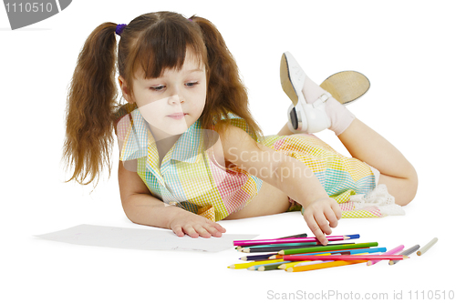 Image of Little girl draws with crayons