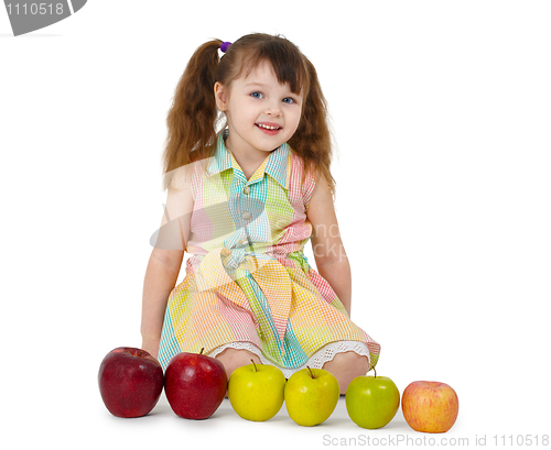 Image of Little girl and train of apples
