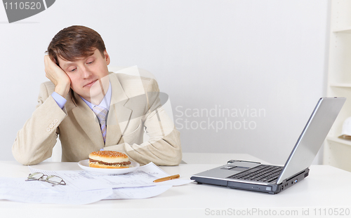 Image of Businessman, dreamily looking at sandwich