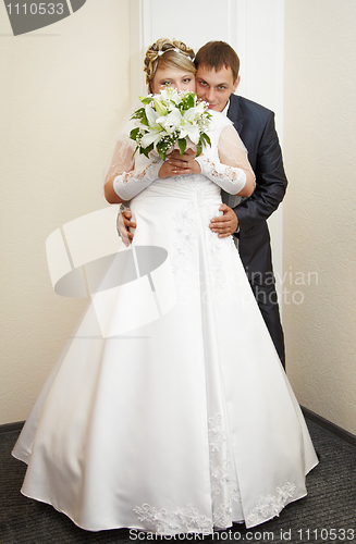 Image of Groom hugging beautiful bride