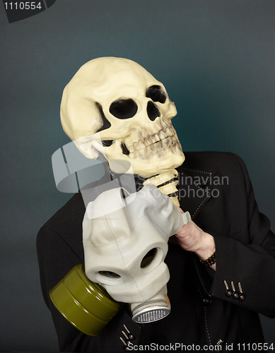 Image of Man in a mask of death puts gas mask