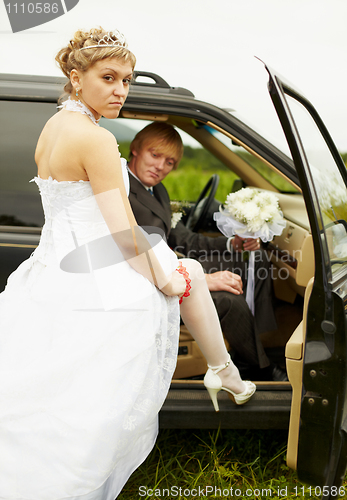 Image of Sexual bride and groom in car