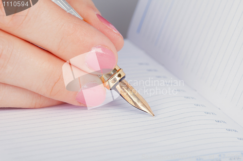 Image of Golden pen and notebook