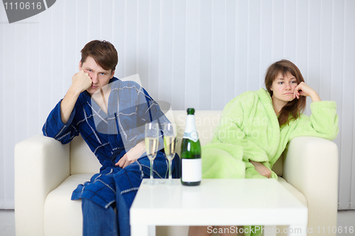 Image of Couple sitting on couch after a quarrel