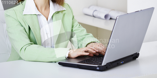 Image of Woman works with computer on workplace at office
