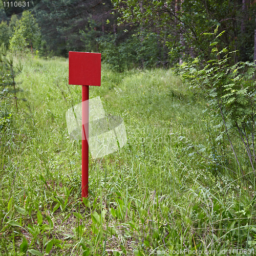 Image of Red metal plate near forest