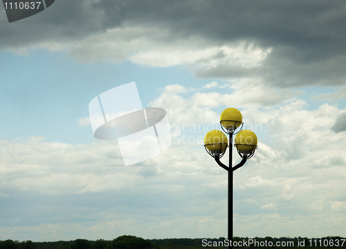 Image of Ancient lamppost against evening sky