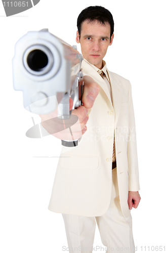 Image of Man in suit aims us in face with pistol
