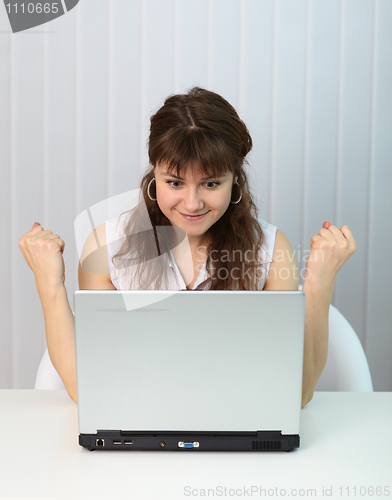 Image of Young girl is happy looking at computer screen