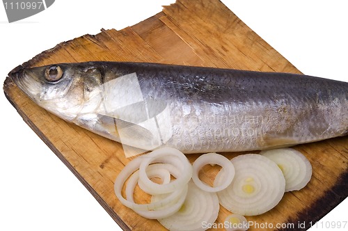 Image of Herring with onion on old wooden board