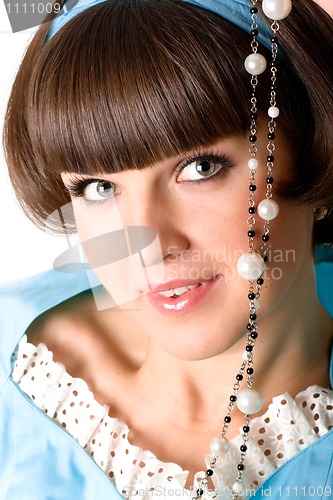 Image of woman in blue dress with pearl beads