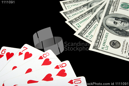 Image of Playing cards and money on black background