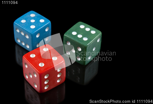 Image of Red, green and blue dices on black background