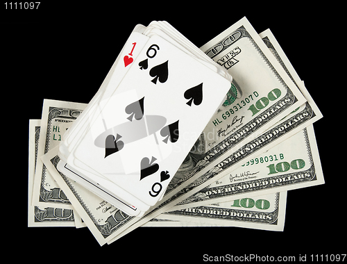 Image of Deck of cards and money on black background