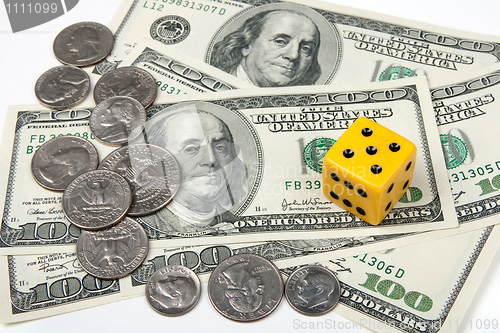 Image of Yellow dice and money