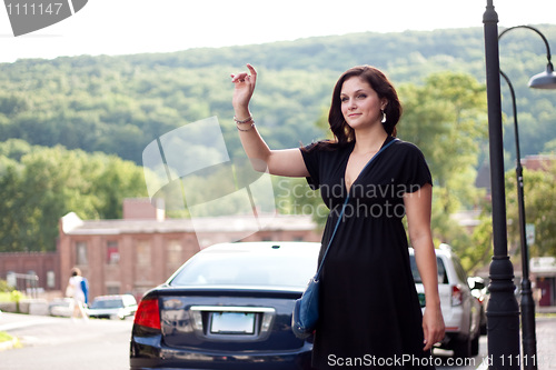 Image of Woman Hailing a Taxi Cab