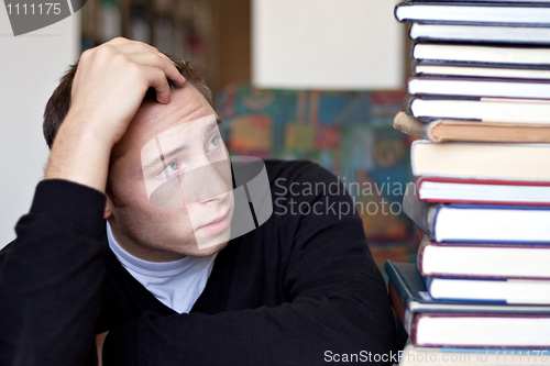 Image of Stressed Student Looks At Books