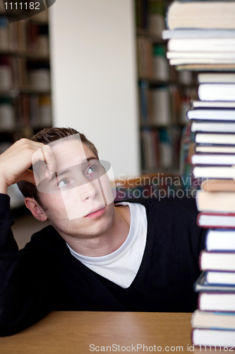 Image of Stressed Student Looks At Book Pile