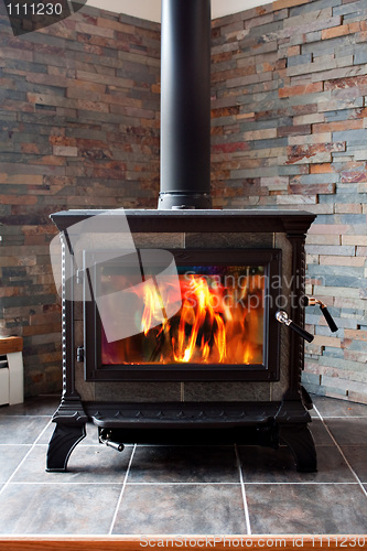 Image of Burning Cast Iron Wood Stove Heating