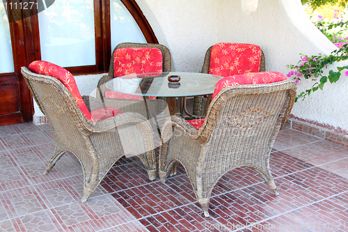 Image of wicker chair and table outdoors