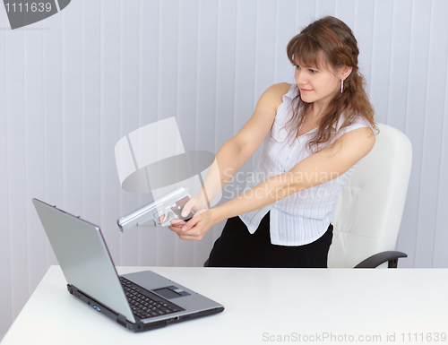 Image of Woman fired a pistol at computer screen