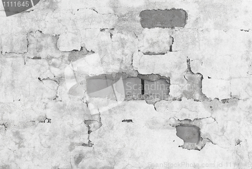 Image of Brick wall covered with broken plaster