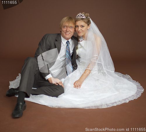 Image of Happy newly-married couple on brown background