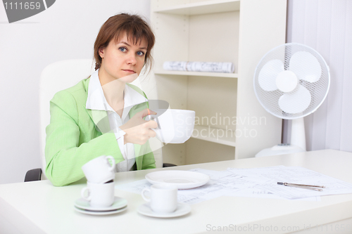 Image of Woman with very big cup in hand