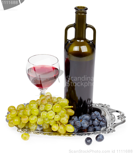 Image of Bottle of red wine, glass and grapes - still life