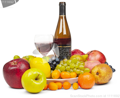 Image of Bottle and glass of red wine among fruit - still life