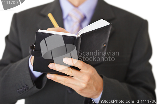 Image of Man makes entry in organizer