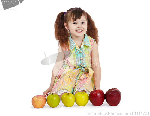 Image of Happy child with apples of different color and size