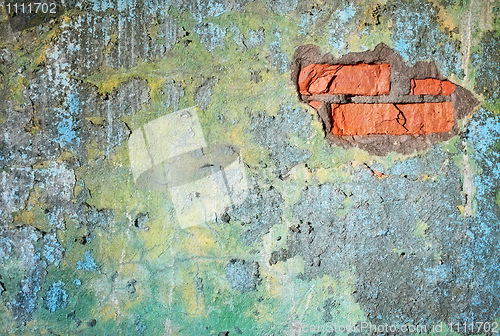 Image of Dirty old wall with damage. We see bricks.