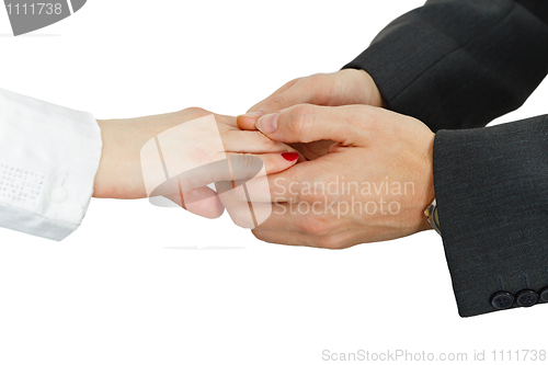 Image of Women's hand in men's hands on white