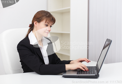 Image of Tired woman working in an office with computer