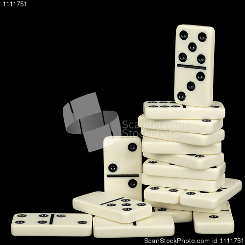 Image of Pile of dominoes isolated on black background