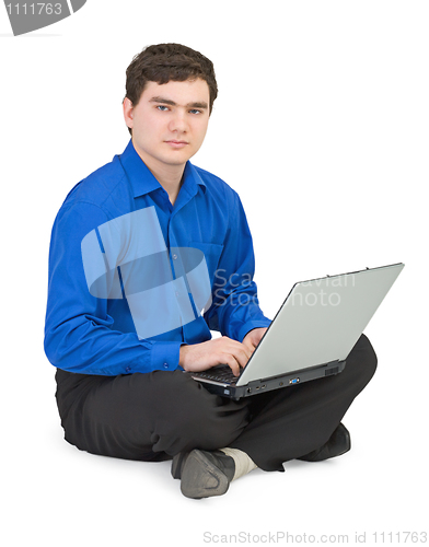 Image of Businessman sits on a floor with the laptop